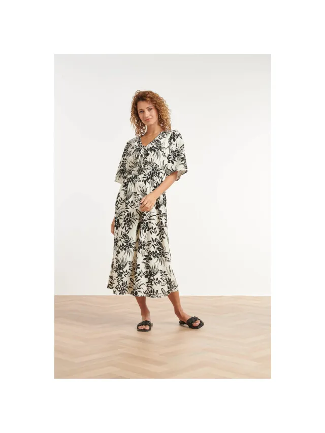Smashed Lemon Zwart-witte jurk met tropische print en strikdetail